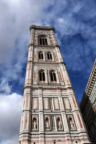 The white marble santa maria del fiore cathedral, located in piazza del Duomo in the historic center of Florence, is next to the Giotto bell tower